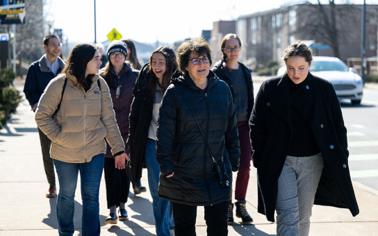 Photo of Cindy Bank and students walking outdoors